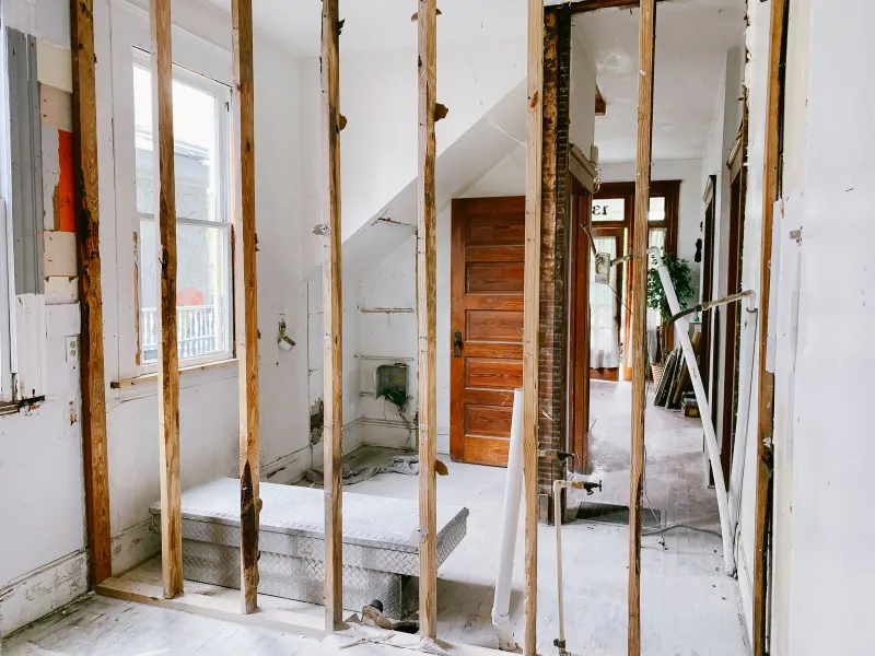 A room stripped to its wall studs during a renovation