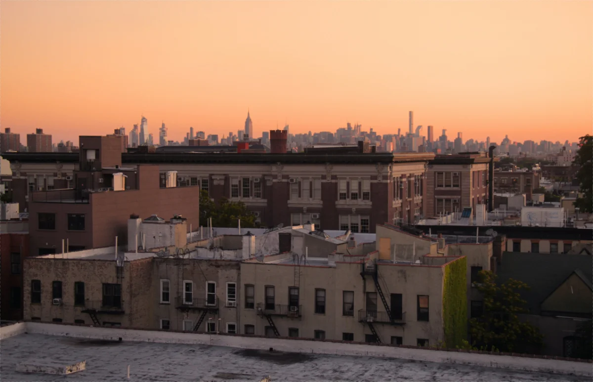 NYC rooftops and the Manhattan skyline at dusk