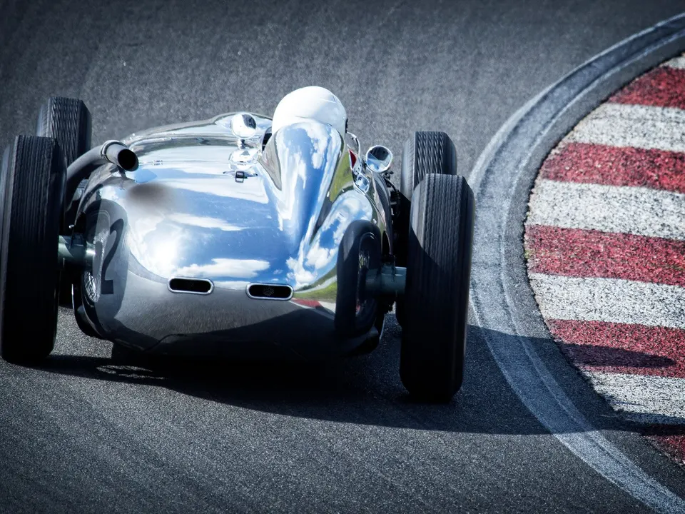 A vintage open wheel race car on a track